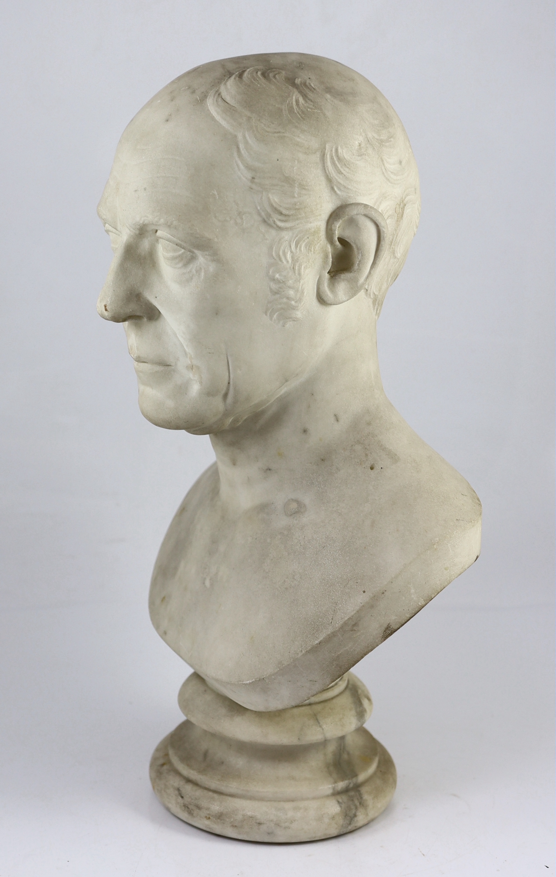 A carved white marble bust of a gentleman, second quarter 19th century, 30cm wide, 54cm high